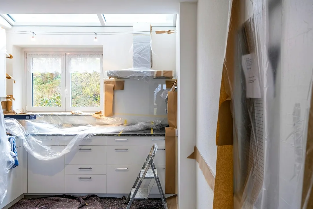 Een keuken tijdens renovatie, met afgedekte onderdelen. — illustratieve foto