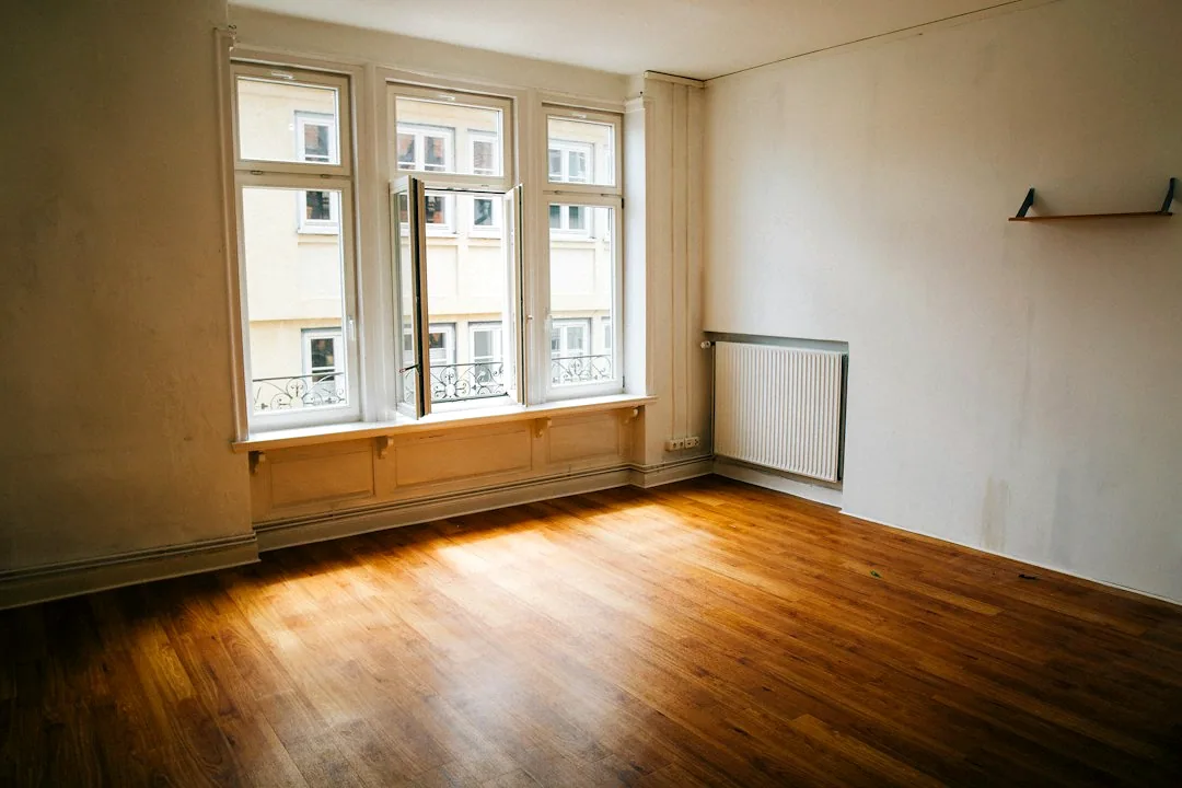 Een lege kamer met daglicht door houten raamkozijnen. — illustratieve foto