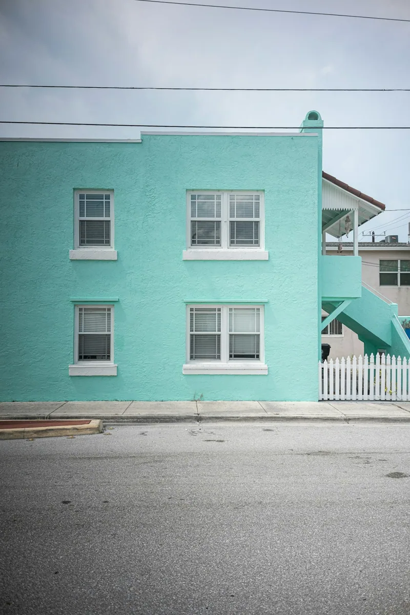 Een turquoise gevel met raamopeningen. — illustratieve foto