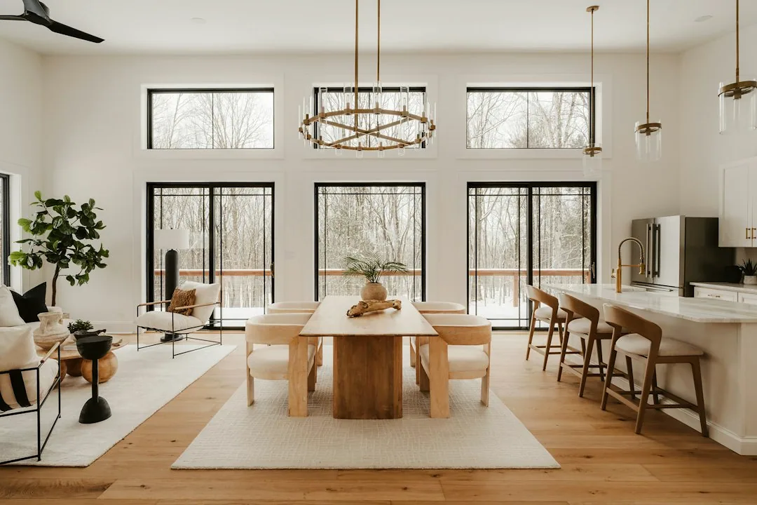 Interior inspiration: a bright open-plan kitchen with tall windows and calm wall surfaces.